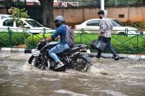 Vehicles struggle through water-logged streets after rains lashed Bengaluru.