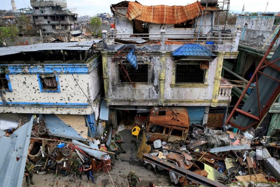 Damaged buildings and houses are seen as government troops continue their assault on its 105th day of clearing operations against pro-IS militants who have seized control of large parts of Marawi City, Philippines. Marawi City,Philippine city,Islamic State,government forces fight