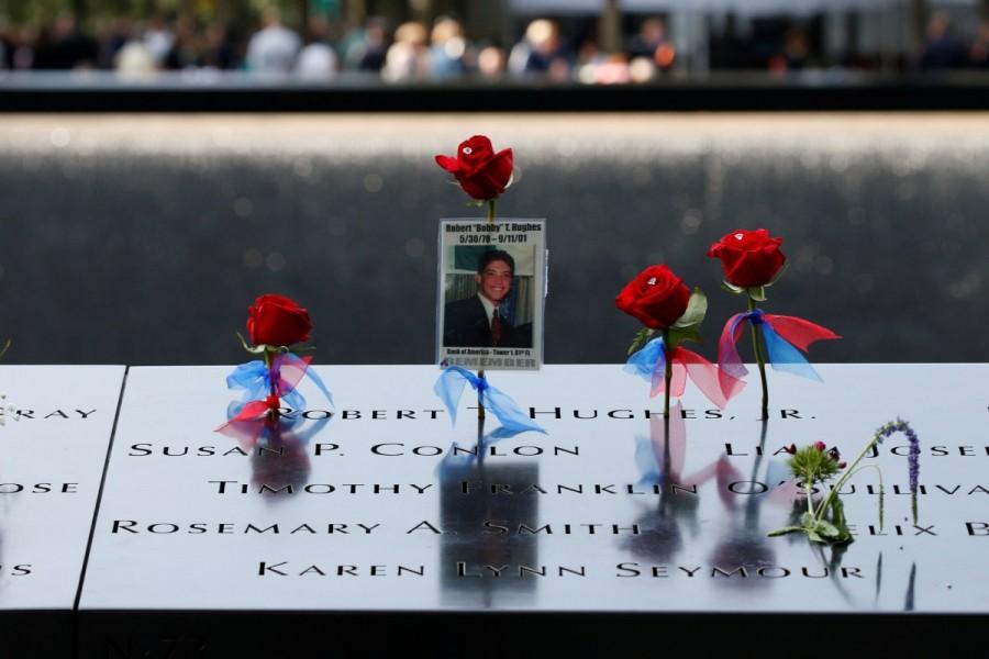 Flowers and mementos left among names at the edge of the south reflecting pool at the National 9/11 Memorial and Museum. Remembering 9/11,Remembering 9/11: 16 years on,9/11,9/11 attacks,9/11 anniversary,16th anniversary 9/11