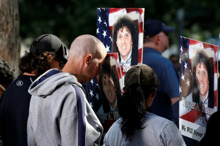 Loved ones of victim Wayne A. Russo, who was killed in the attacks at the World Trade Center, pause with photos of him at the National 911 Memorial and Museum. Remembering 9/11,Remembering 9/11: 16 years on,9/11,9/11 attacks,9/11 anniversary,16th anniversary 9/11