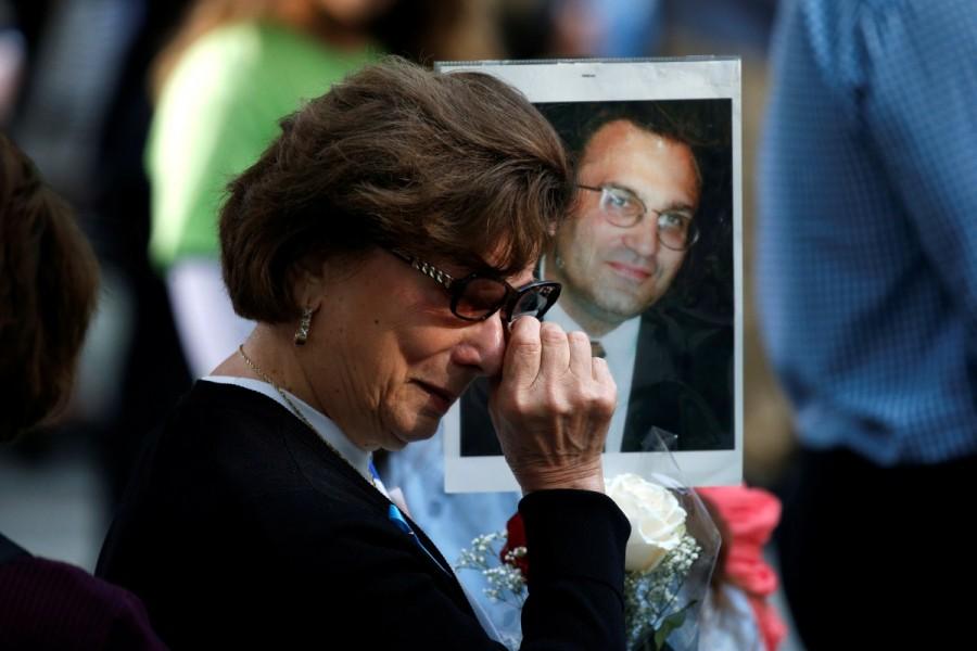 A woman wipes away tears as she holds a photograph of Alex Ciccone, a victim of the attacks, at the National 9/11 Memorial and Museum. Remembering 9/11,Remembering 9/11: 16 years on,9/11,9/11 attacks,9/11 anniversary,16th anniversary 9/11