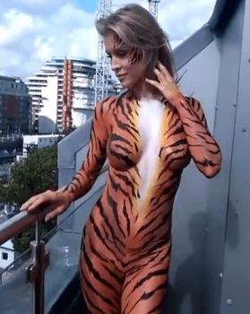 Model Joanna Krupa stripped down to nothing but tiger bodypaint outside Londons Houses of Parliament in order to support animal rights.
