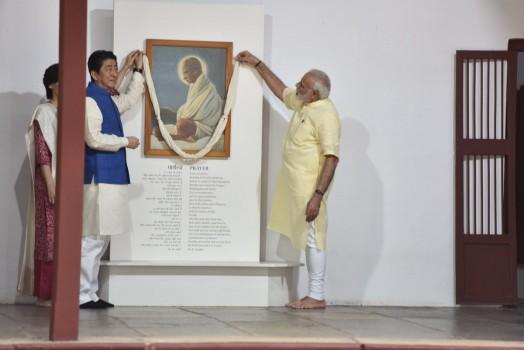 Keeping a date with history, Prime Minister Narendra Modi and his Japanese counterpart Shinzo Abe on Wednesday visited the Sabarmati Ashram soon after the latter's arrival here on a two-day visit. The two leaders and Japan's First Lady Akie Abe paid floral tributes to a portrait and a bust of Mahatma Gandhi. Modi took the visiting dignitaries on a tour of the Ashram as the trio posed for pictures, including one in front of a charkha. After his return to India from South Africa, Mahatma Gandhi set up his first ashram at Kochrab in Ahmedabad in May 1915 but then shifted it to the banks of the Sabarmati river in June 1917.