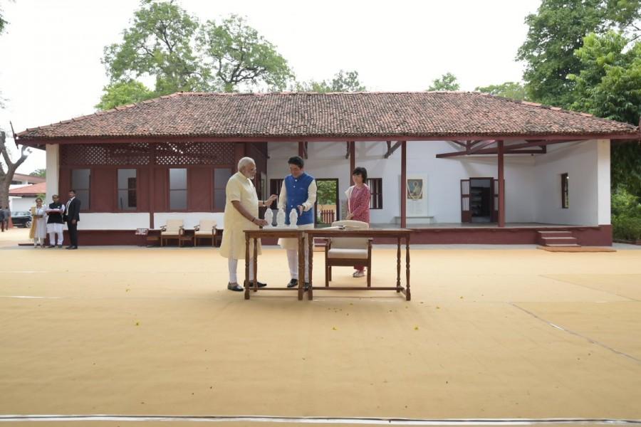 The Sabarmati Ashram was home to Gandhi from 1917 until 1930 and served as one of the main centres of the Indian freedom struggle. During Wednesday's visit, Abe and his wife also signed on the visitors' book of the Ashram. Earlier in the day, breaking protocol, Modi personally received Abe at the Sardar Vallabhhai Patel International airport with a warm hug. The visiting dignitary was given a guard of honour while artists from different parts of the country presented a variety of programmes. Narendra Modi,Shinzo Abe,Prime Minister Narendra Modi,Sabarmati Ashram,Mahatma Gandhi
