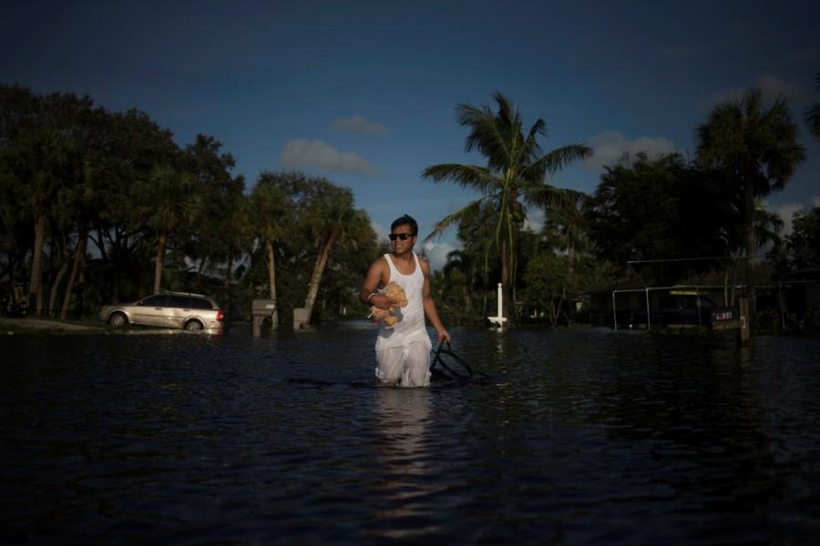 A man wades out of flood waters from his house in Bonita Springs. Hurricane Irma,Florida Hurricane Irma,devastation in Florida