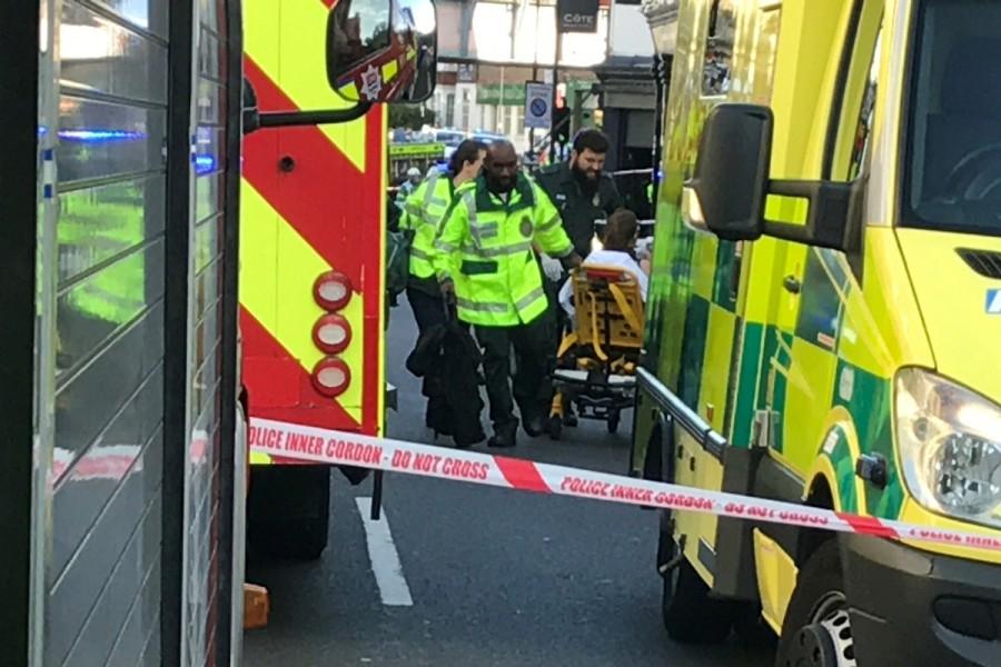Emergency personnel attend to a person after an incident at Parsons Green underground station in London. London underground,London Underground explosion,london underground,London underground blast,London Underground Station,Blast at London underground