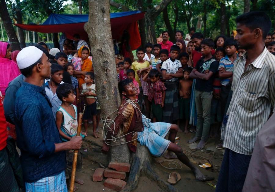 A man accused of stealing money from Rohingya refugees is tied to a tree at a makeshift refugee camp near Balukhali in Cox's Bazar, Bangladesh. Myanmar,Myanmar violence,Muslim Rohingya,Rohingya flee Myanmar violence