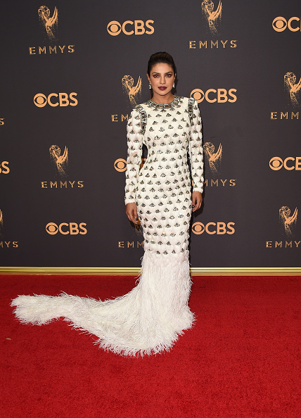 At the red carpet, Priyanka made heads turn with her full-sleeves ensemble, which was adorned with crystals and had a feather skirt train. With her hair neatly tied in a ponytail, her lips done up in deep berry red and dramatic eye make-up, the "Quantico" star exuded a fierce and powerful demeanour at the red carpet of the gala. Emmy Awards 2017,Emmy Awards,Priyanka Chopra dazzles in white,Priyanka Chopra,Priyanka Chopra at Emmy Awards 2017,Priyanka Chopra at Emmy Awards