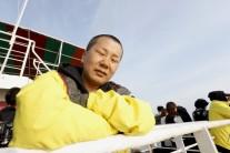A relative of the victims of the Sewol disaster weeps during a ceremony on the eve of the first anniversary