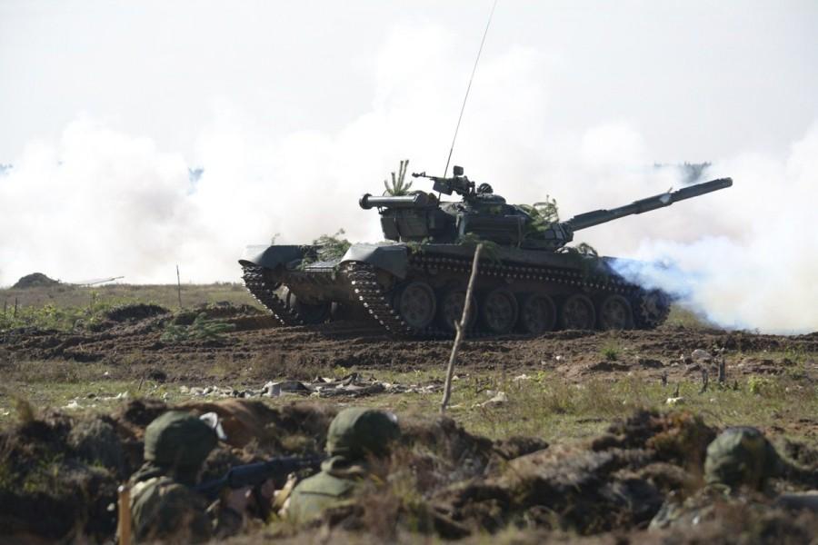 Soldiers are seen in a trench as a tank fires during the Zapad-2017 war games. Russian war games,Russian war,Russia’s biggest war games,Russian war games rattle West,Mi-8 helicopter,Vladimir Putin