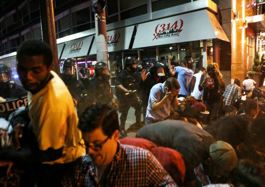 Police officers, ordering the last remaining protesters on the street to get on the ground, spray a chemical agent at those not complying, after the not guilty verdict in the murder trial of Jason Stockley, a former St. Louis police officer charged with the 2011 shooting of Anthony Lamar Smith, in St. Louis, Missouri, U.S., September 17, 2017. St. Louis Justice Center,St. Louis Justice,Protests in St. Louis,Protests at St. Louis,Jason Stockley,St. Louis police officer Jason Stockley,Anthony Lamar Smith