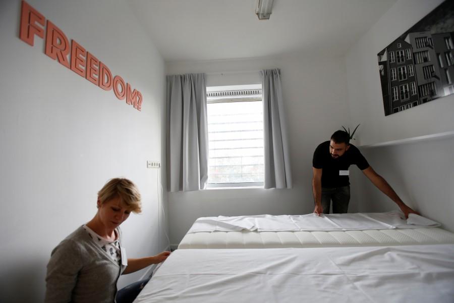 Housekeeping Manager Ella Delsanto and Monjid, an asylum seeker from Syria, are seen inside the former Bijlmerbajes prison. The Bijlmerbajes once housed notorious criminals, including the group that kidnapped beer magnate Freddy Heineken in 1983 for a 17 million euro ransom. The prison's name comes from the Bijlmer neighborhood to the southeast and "bajes", a Yiddish slang term for jail that entered Dutch via Amsterdam's Jewish population. Former Dutch prison,Dutch prison,Netherlands,prison now offers refuge as hotel