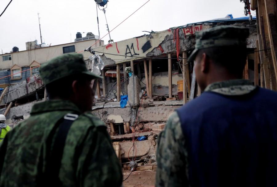 Soldiers stand near parts of a collapsed school building, September 21, 2017. Mexico races to find survivors,Rescuers labor,Enrique Rebsamen School,earthquake