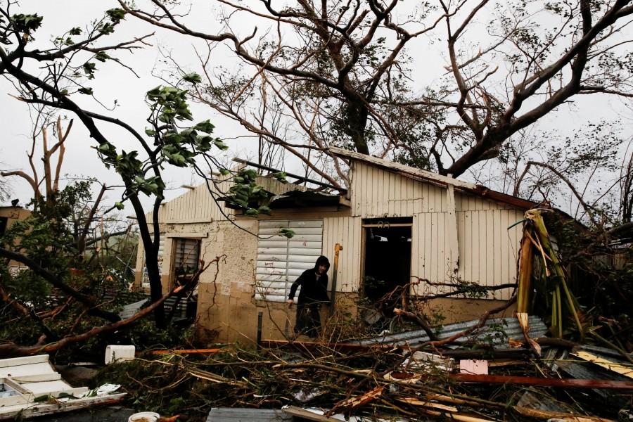 A man looks for valuables in the damaged house of a relative after the area was hit by Hurricane Maria in Guayama, Puerto Rico. Hurricane Maria,Hurricane Maria in Puerto Rico,Hurricane Maria slams Puerto Rico,U.S. territory