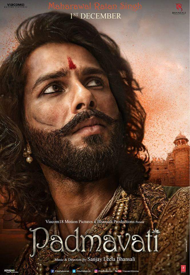 Days after actress Deepika Padukone's royal look from "Padmavati" was unveiled, the makers of the upcoming film have shared an image of actor Shahid Kapoor, who looks every inch of a warrior king in the poster. Shahid will be seen playing the role of MahaRawal Ratan Singh, husband of Deepika's character in the Sanjay Leela Bhansali's directorial. In the poster shared on Monday morning, Shahid, whose face is slashed with battle scars, is seen sporting a heavy bearded look, twirled moustache, kohl filled eyes, a red 'tika' on his forehead and pearl jewellery adding to his royal look. Shahid Kapoor,Maharawal Ratan Singh,Shahid Kapoor as Maharawal Ratan Singh,Deepika Padukone,Shahid flaunts bruised,brave avatar,Shahid Kapoor flaunts bruised,Padmavati first look