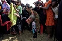 A Rohingya refugee reacts as people scuffle while waiting to receive aid in Cox's Bazar, Bangladesh.