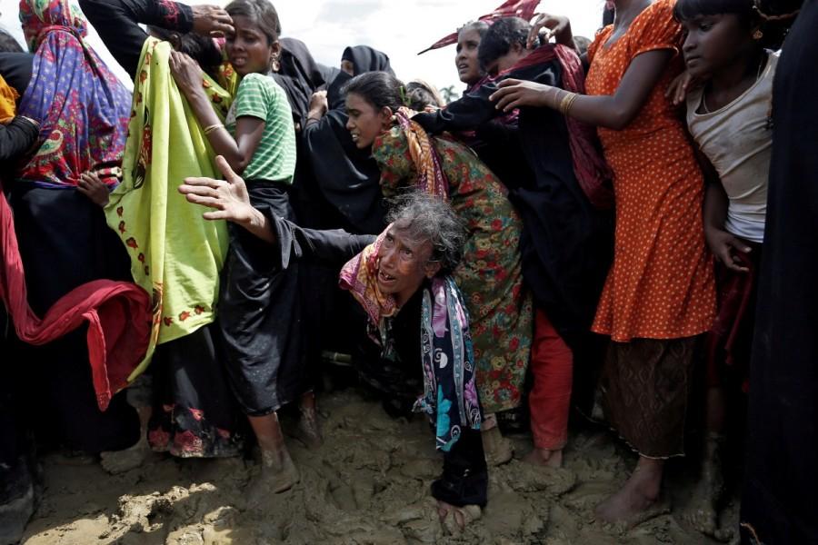 A Rohingya refugee reacts as people scuffle while waiting to receive aid in Cox's Bazar, Bangladesh. Rohingya,Rohingya flee Myanmar,Violence in Myanmar,480,000 Rohingya,refuge in Bangladesh