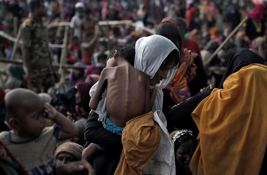 A woman carries her ill child in a refugee camp at Cox's Bazar, Bangladesh. Rohingya,Rohingya flee Myanmar,Violence in Myanmar,480,000 Rohingya,refuge in Bangladesh