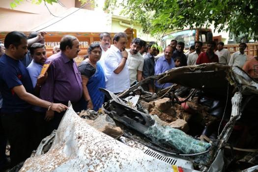 A view of a damaged four-wheeler after a compound wall collapsed due to heavy rains in Bengaluru on Sept 27, 2017.