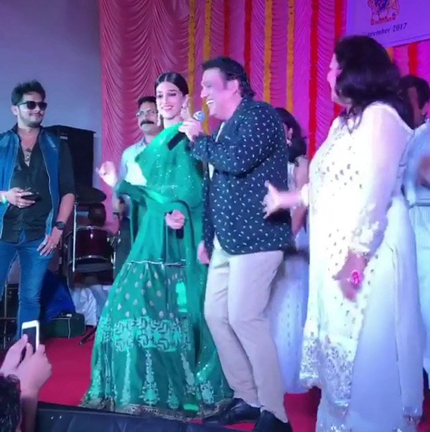 Kriti Sanon who visited a Navaratri event last night had a fangirl moment. The actress shared the stage with one of Bollywood's iconic actors Govinda. Kriti Sanon took to her social media to share her Fan girl moment wherein she was seen shaking her legs with the dancing legend, Govinda. Kriti Sanon dances with Govinda,Govinda,Kriti Sanon,actress Kriti Sanon,actor Govinda