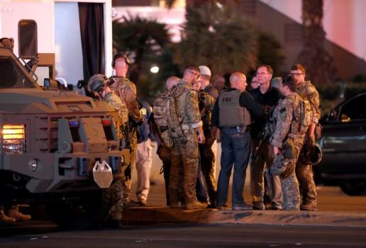 FBI agents confer in front of the Tropicana hotel-casino on October 2, 2017, after a mass shooting during a music festival on the Las Vegas Strip in Las Vegas.