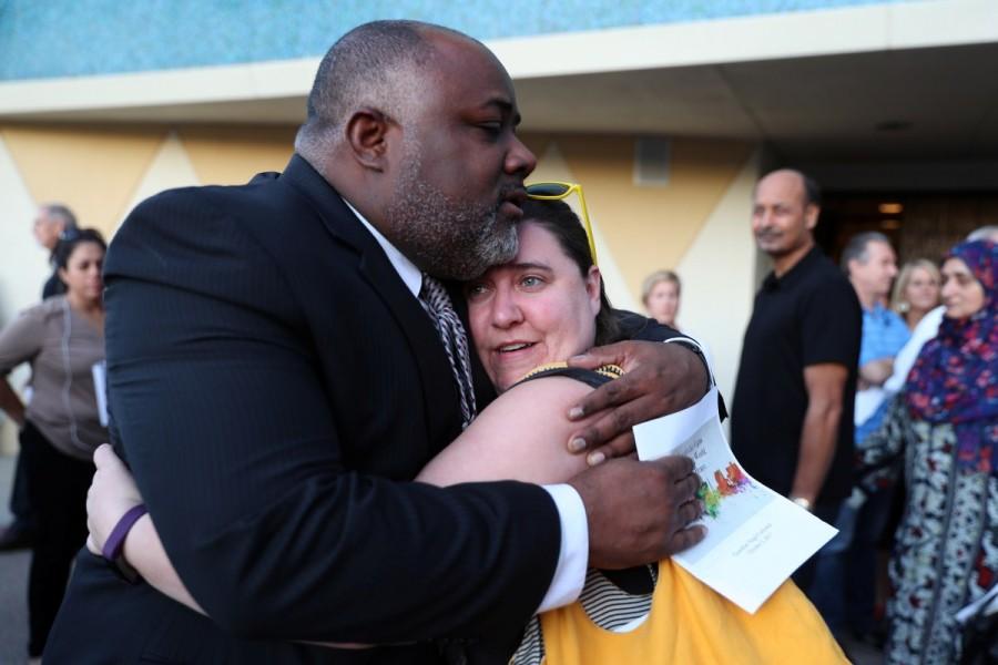 People mourn after an interfaith memorial service for victims of the Route 91 music festival mass shooting outside the Mandalay Bay Resort and Casino in Las Vegas, Nevada. Las Vegas,Mourning for Las Vegas,Las Vegas victims,Las Vegas shooting victims