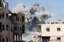 Smoke rises at the positions of the Islamic State militants after an air strike by the coalition forces near the stadium in Raqqa, Syria.