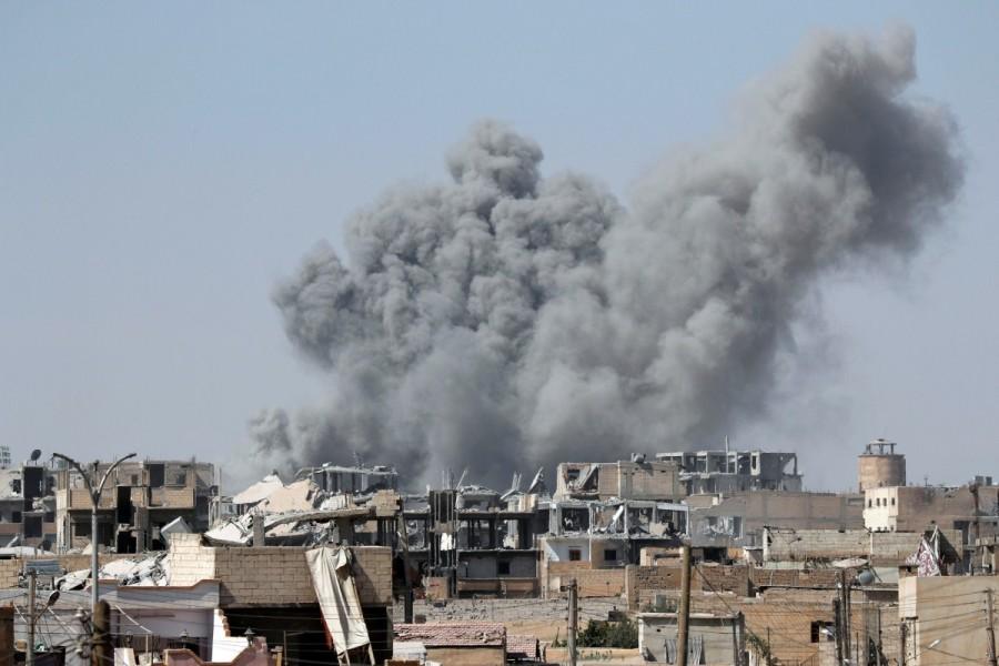 Smoke rises in the stadium as members of Syrian Democratic Forces battle with Islamic State militants in Raqqa. Battle for Islamic State,Islamic State,U.S.-backed Syrian Democratic Forces,Syrian Democratic Forces