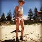 Amber Heard shows off toned figure in a tiny white bikini.