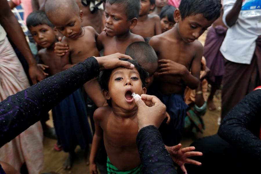 A Rohingya refugee child gets an oral cholera vaccine in a refugee camp near Cox's Bazar, October 11, 2017. Aid workers worry they lack the staff to get the vaccines out quickly, while the WHO says it urgently needs $10.2 million to do the job properly. The first round of the vaccination campaign will cover 650,000 people aged one year and older. A second round will target 250,000 children aged between one and five with an additional dose for extra protection. Rohingya refugee camps,Rohingya camps,refugee camps,Bangladesh