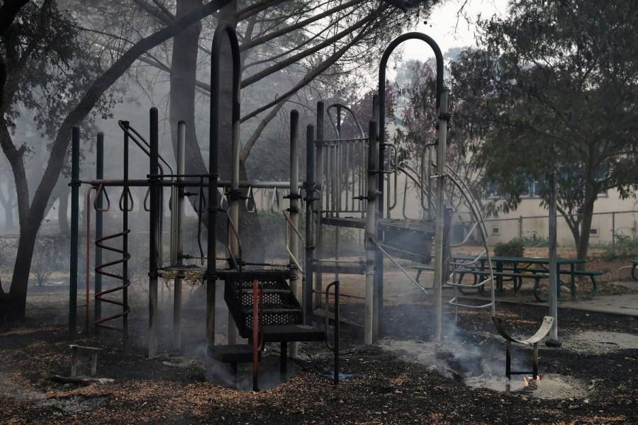 Smoke rises from a playground in front of Dunbar Elementary School during the Nuns Fire in Sonoma. California,California landscape,Tubbs Fire,Sonoma and Napa counties