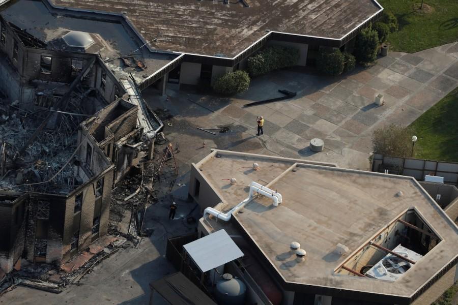 A worker takes photographs of a building destroyed by the Tubbs Fire in Santa Rosa. California wildfire,California wildfire from above,California wildfire aftermath,Tubbs Fire,Aerial views of California wildfire