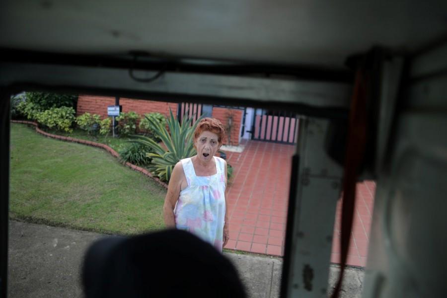A local resident reacts as a mail man from the U.S. Postal Service arrives at her house at an area affected by Hurricane Maria in San Juan. Puerto Rico,Hurricane Maria,U.S. Postal Service