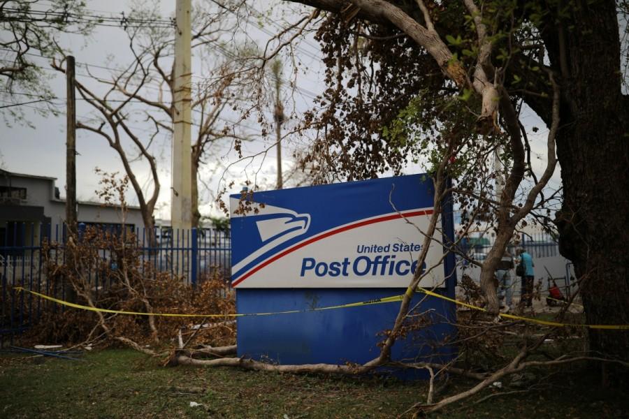 A U.S. Postal Service office sign is seen at a damaged area of San Juan after Hurricane Maria, in Puerto Rico. Puerto Rico,Hurricane Maria,U.S. Postal Service