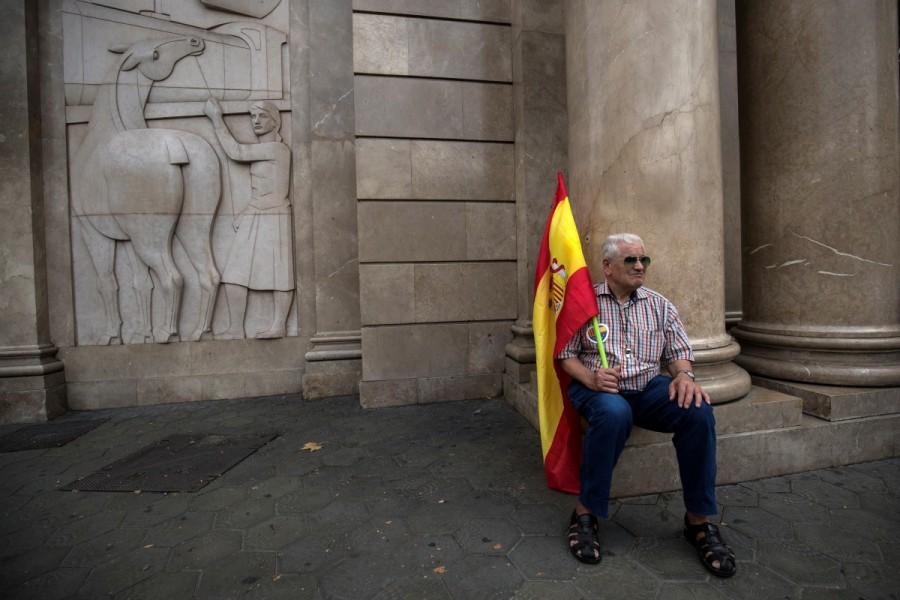 A man holds a Spanish flag during Spain's National Day in Barcelona. Spain celebrates National Day,National Day,Spain National Day