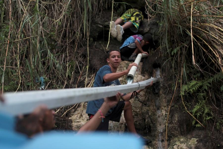 People collect mountain spring water, after Hurricane Maria hit the island, in Corozal. Puerto Ricans,drinking water,search for water,Hurricane Maria hit,Hurricane Maria