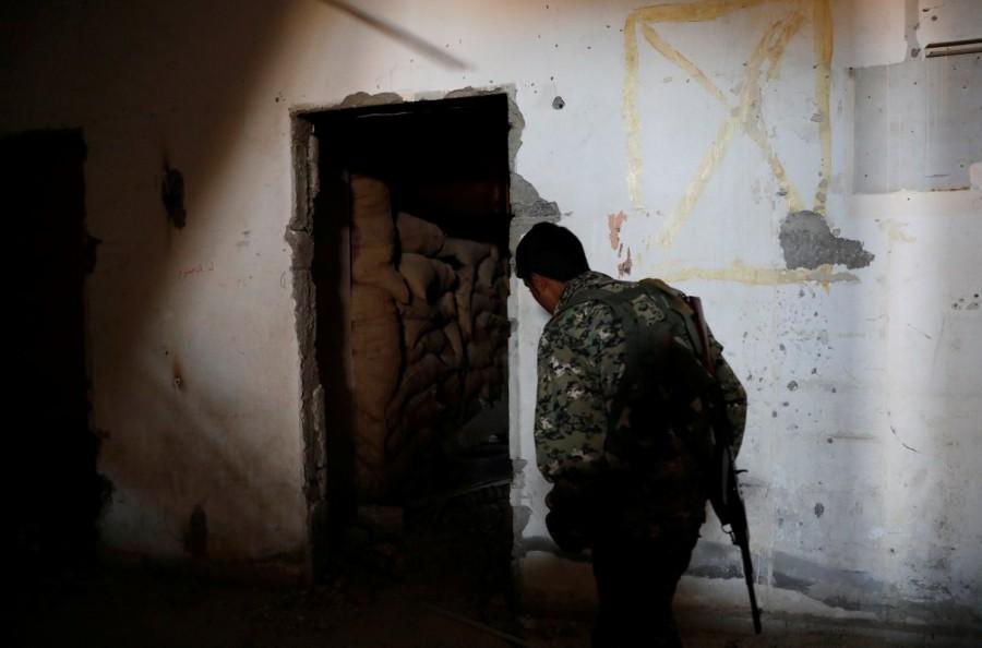 A fighter of the Syrian Democratic Forces inspects a bunker of the Islamic State militants under the stadium in Raqqa, Syria. Islamic State bunker,Islamic State,Raqqa,Syrian Democratic Forces,Syrian Democratic Forces (SDF),Islamic State militants