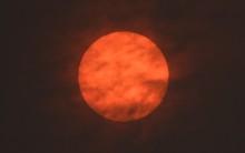 The sun is seen after dawn after the Met Office reported that storm Ophelia has drawn dust north from the Sahara, near Exeter.