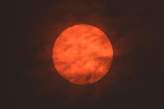 The sun is seen after dawn after the Met Office reported that storm Ophelia has drawn dust north from the Sahara, near Exeter.