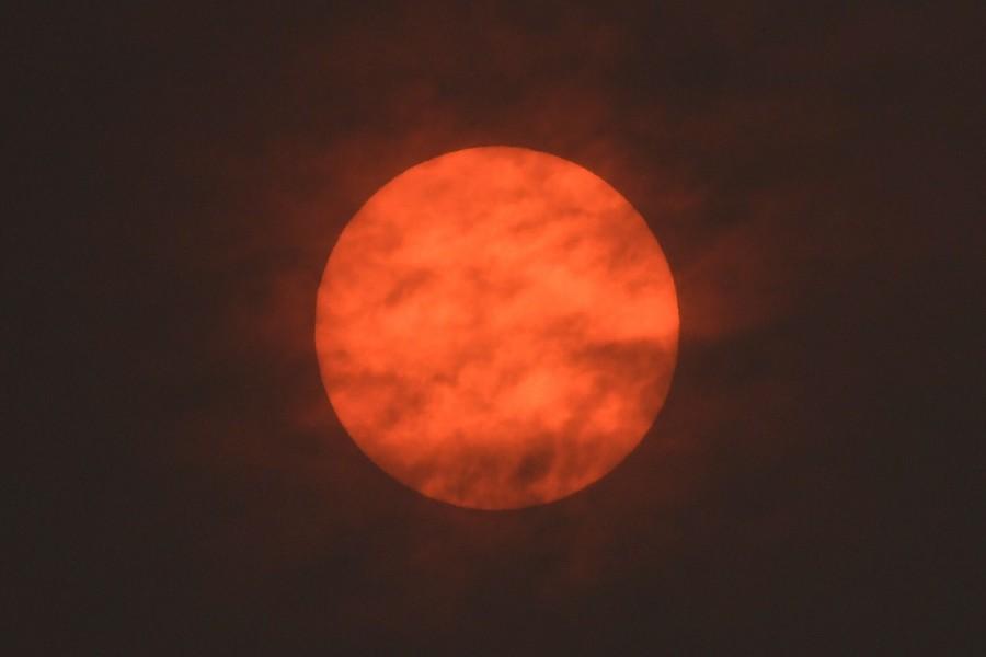 The sun is seen after dawn after the Met Office reported that storm Ophelia has drawn dust north from the Sahara, near Exeter. Ophelia turns London sky red,London sky red,London sky,Ophelia filters sunlight