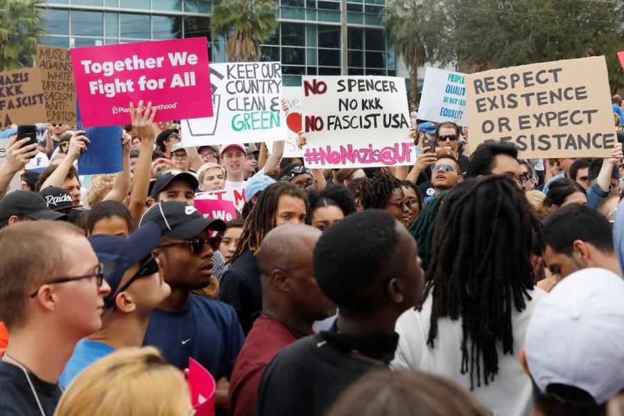 Demonstrators rally before the speech by Richard Spencer. Richard Spencer,Florida campus,University of Florida,Go home Nazis