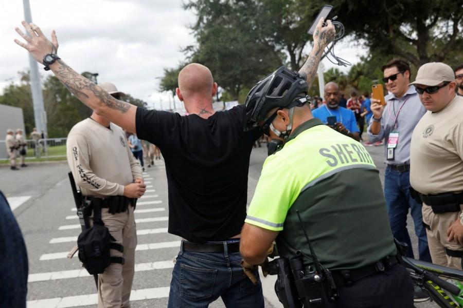 Tyler Tenbrink, a self proclaimed white nationalist who drove from Texas, is stopped by the police before the speech by Richard Spencer. Richard Spencer,Florida campus,University of Florida,Go home Nazis