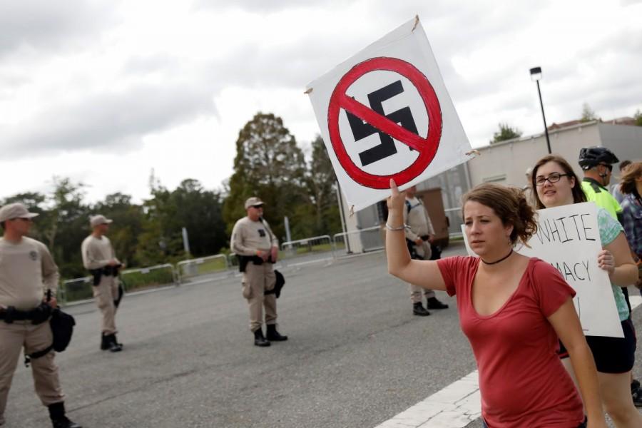 Demonstrators rally before the speech by Richard Spencer. Protesters chanting "Go home Nazis" sought to drown out the speech by white nationalist Richard Spencer at the University of Florida, as the campus erected barricades and deployed hundreds of police officers to guard against unrest. Richard Spencer,Florida campus,University of Florida,Go home Nazis