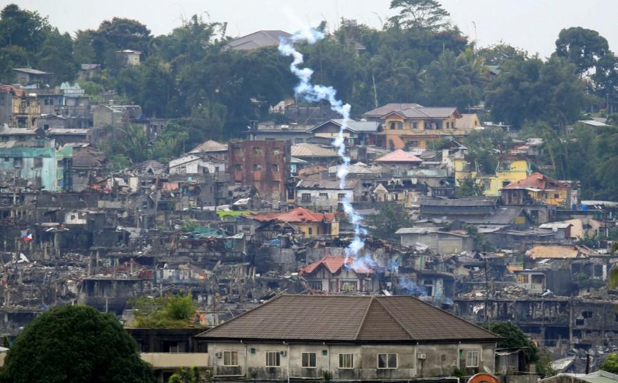 Teargas is fired by government troops as they continue their assault against the pro-Islamic State militant group during a clearing operation. Philippine city,pro-Islamic State,pro-Islamic State rebels