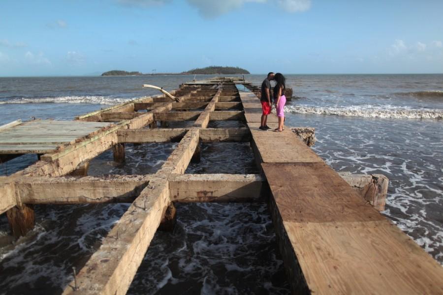 A couple kiss on a damaged pier in Humacao. Puerto Rico,Hurricane Maria,Puerto Rico after Hurricane Maria