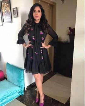 Richa Chadha is wearing a cute cherry print black dress by Kate Spade and teamed it up with sexy pink pumps by Zara.