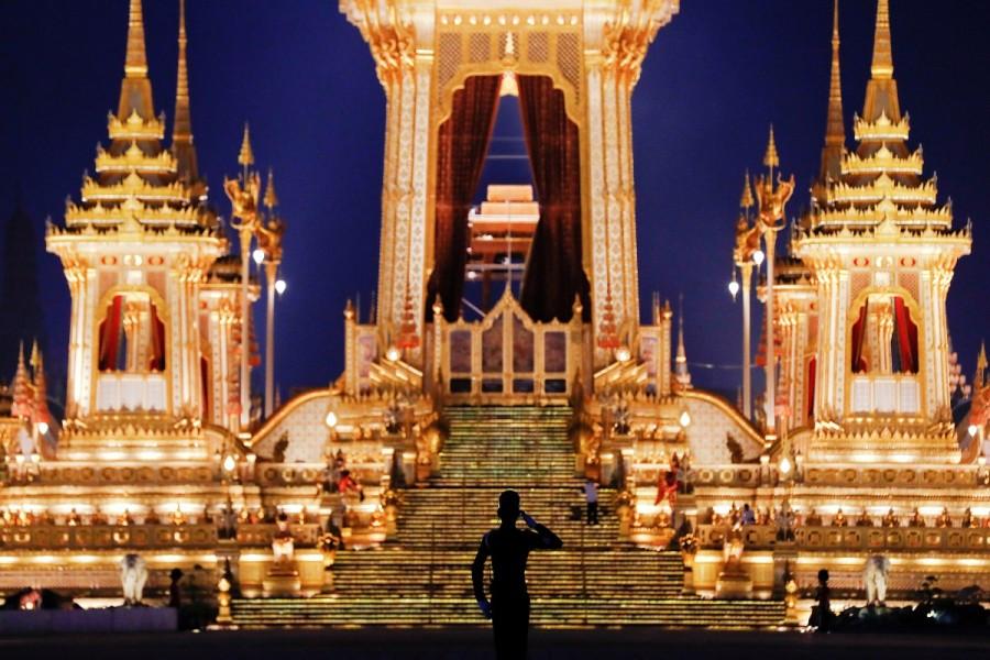 A soldier salutes in front of the Royal Crematorium during a funeral for the late King Bhumibol Adulyadej near the Grand Palace in Bangkok. Thai king,King Bhumibol,Bangkok Grand Palace,Royal cremation for Thai king