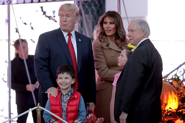 U.S. President Donald Trump (L) and first lady Melania Trump pose for photographs with Attorney General Jeff Sessions (R) and the children he was accompanying while hosting Halloween at the White House on the South Lawn October 30, 2017 in Washington, DC. The first couple gave cookies away to costumed trick-or-treaters one day before the Halloween holiday. Donald Trump and Melania Trump,Donald Trump,Melania Trump,Halloween,Halloween 2017,Donald Trump celbrates Halloween,Melania Trump celbrates Halloween