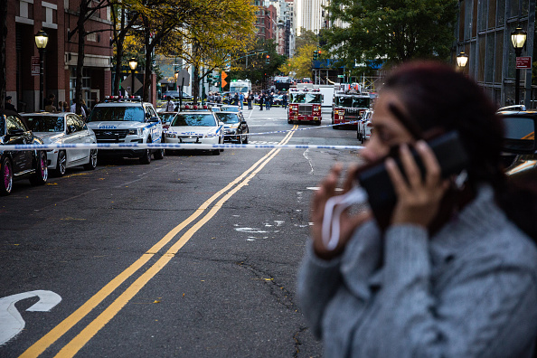 New York Fire Department (NYFD) and New York Police Department (NYPD) vehicles sit parked on a blocked off street after a motorist attack on the West Side of Manhattan in New York, U.S., on Tuesday, Oct. 31, 2017. New York attack,New York terror attack,Argentine,Lower Manhattan,New York,Argentine nationals