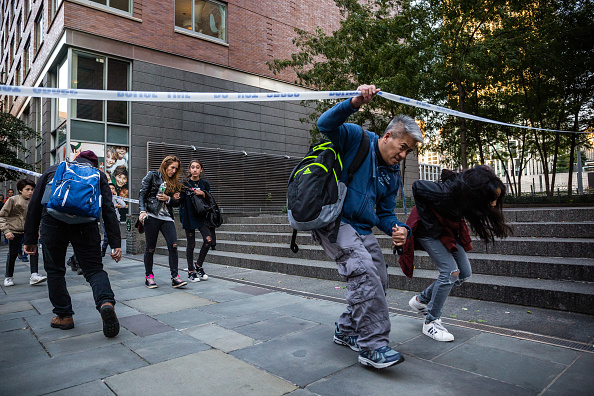 Parents meet their children from nearby schools on a blocked off sidewalk after a motorist attack on the West Side of Manhattan in New York, U.S., on Tuesday, Oct. 31, 2017. A man in a rented pickup truck drove onto a busy bicycle path near the World Trade Center memorial and mowed down people Tuesday, killing at least eight and injuring several others. New York attack,New York terror attack,Argentine,Lower Manhattan,New York,Argentine nationals